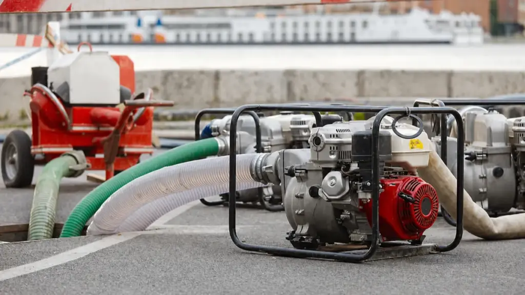 Portable water pump with hoses on industrial worksite