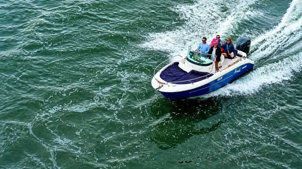 Motorboat with four passengers speeding across open water