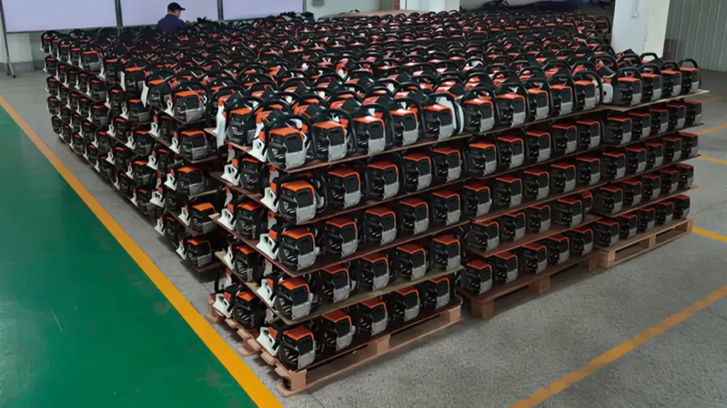 A warehouse floor packed with stacked red chainsaws on pallets
