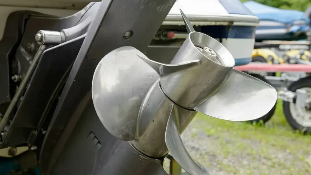 Shiny stainless steel boat propeller on motor mount