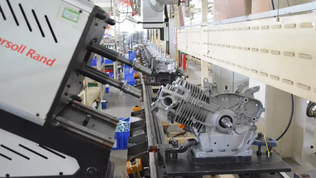 Automated industrial outdoor power equipment assembling engine components on a conveyor line