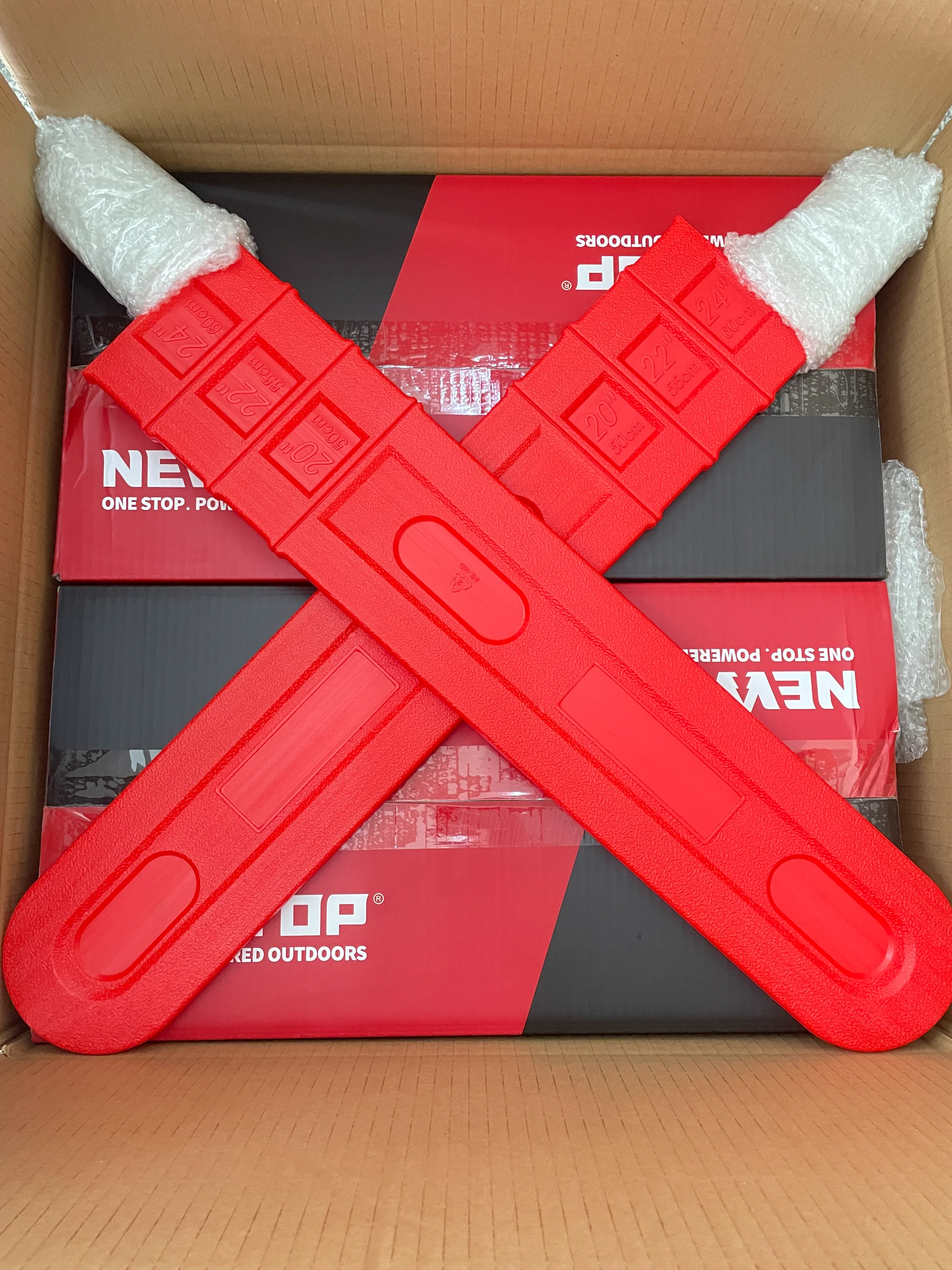 Red tent poles in protective packaging with bubble wrap inside branded NEP outdoor shipping box